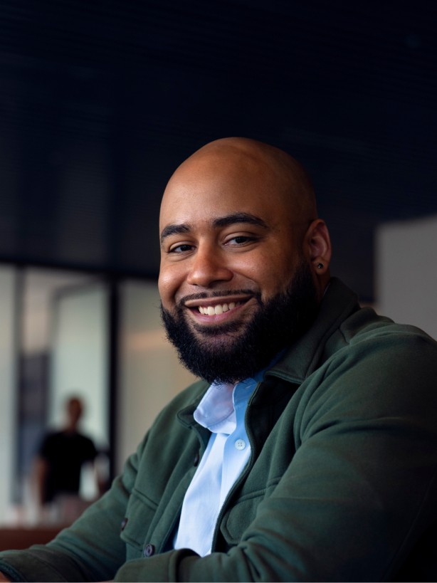 African American male smiling at the camera