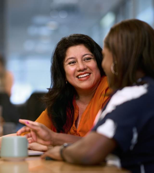 Two women talking and smiling