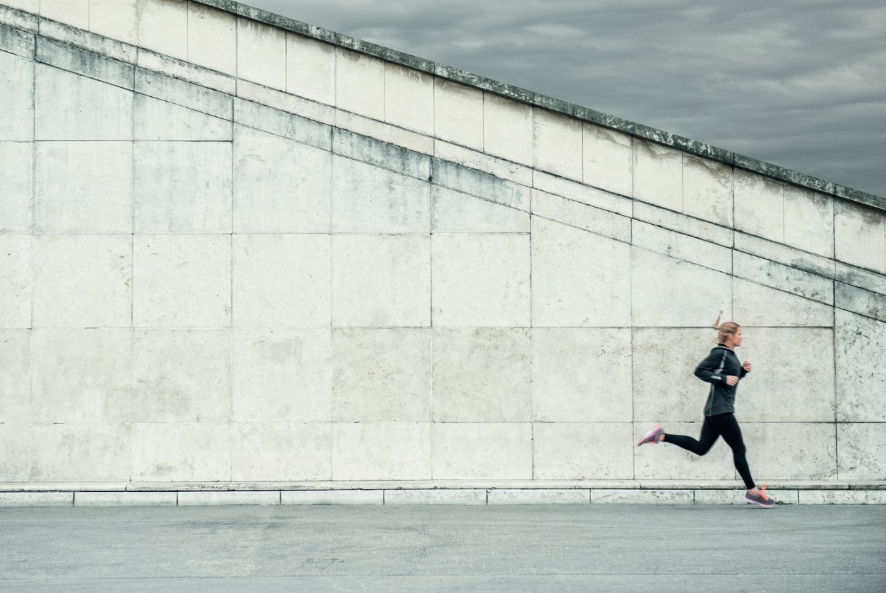 Caucasian woman jogging near staircase