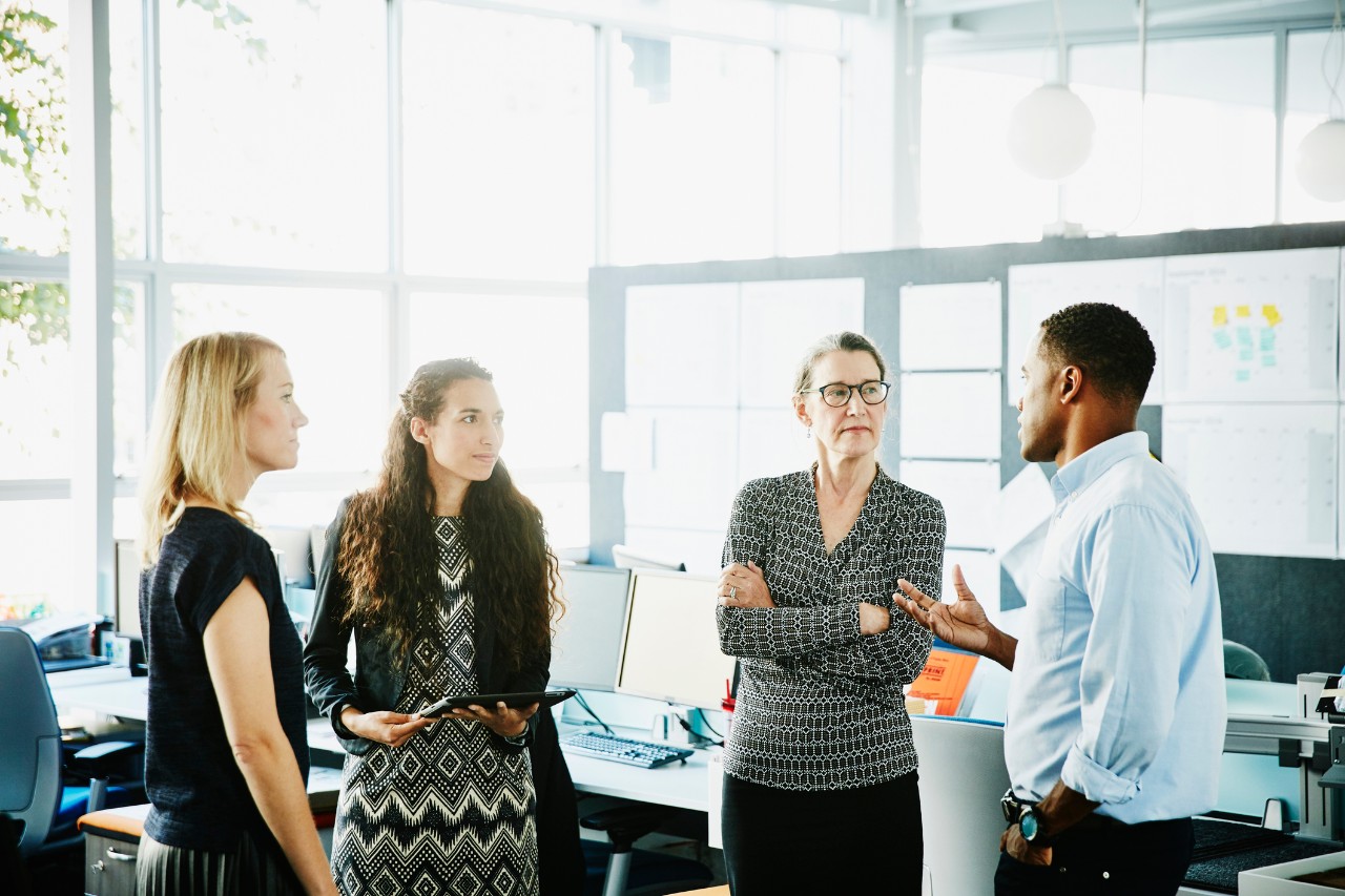 Businessman leading informal meeting in office